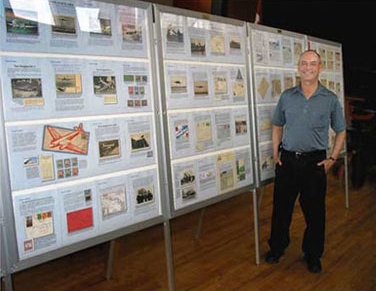 Bob Ingraham with his philatelic exhibit about the KLM DC-2 Uiver